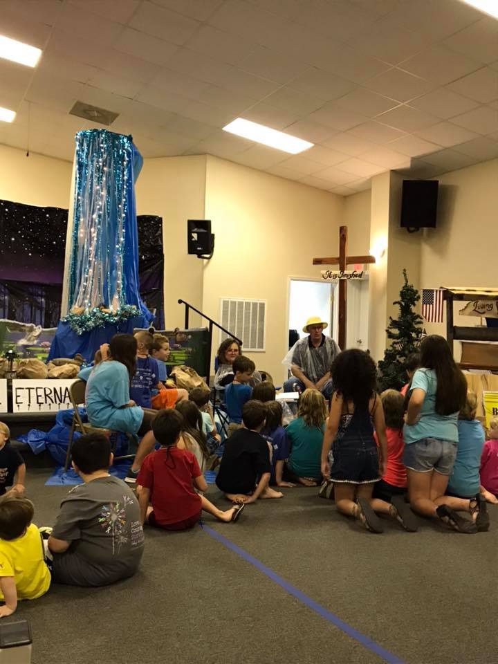 Adults teaching children during a church Bible session